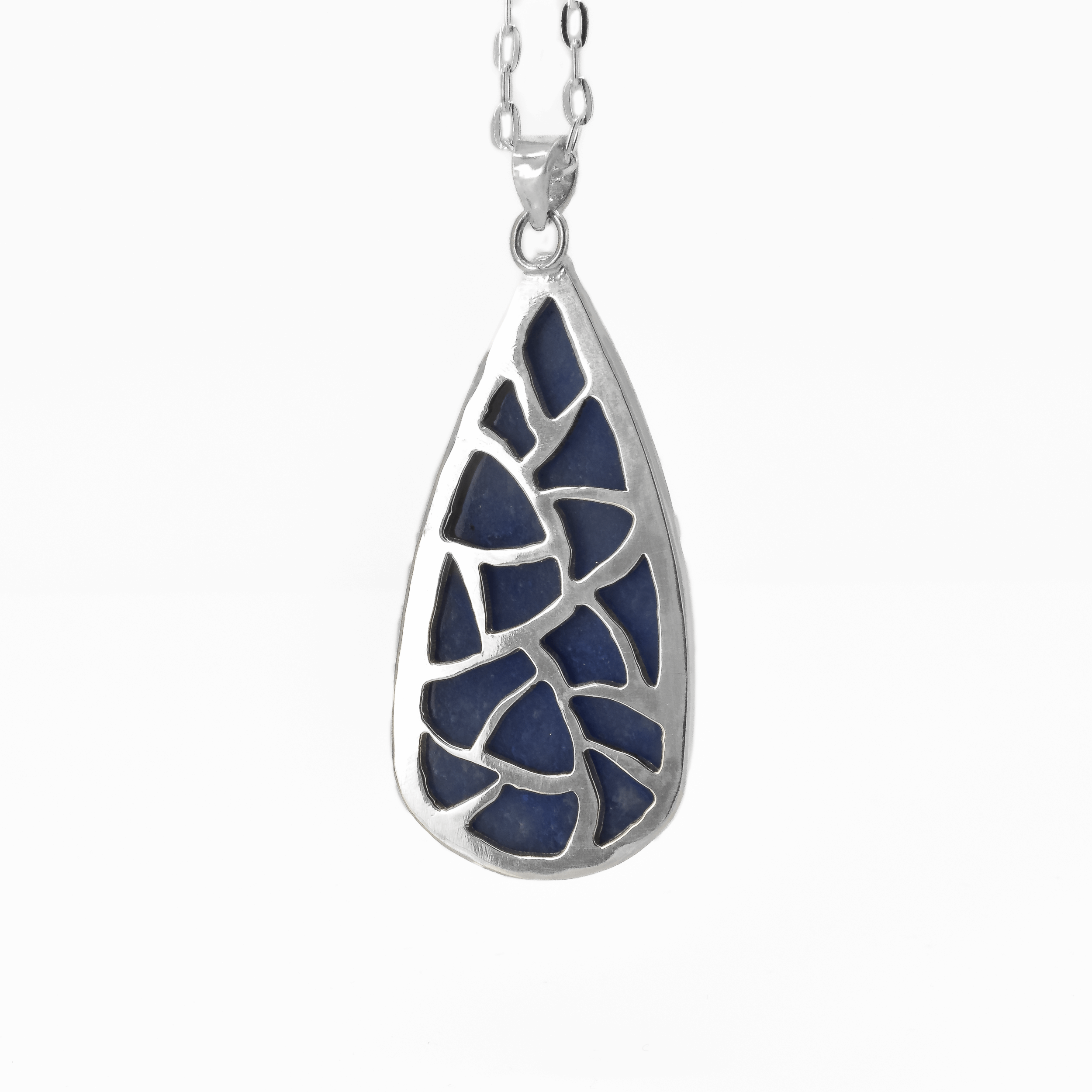 Back of a blue aventurine statement pendant which is pierced out with an irregular design
