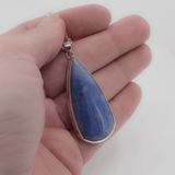 Blue aventurine statement necklace in a teardrop shape shown in hand for scale