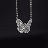 Large butterfly necklace in sterling silver with a faceted Teal Montana Sapphire round stone