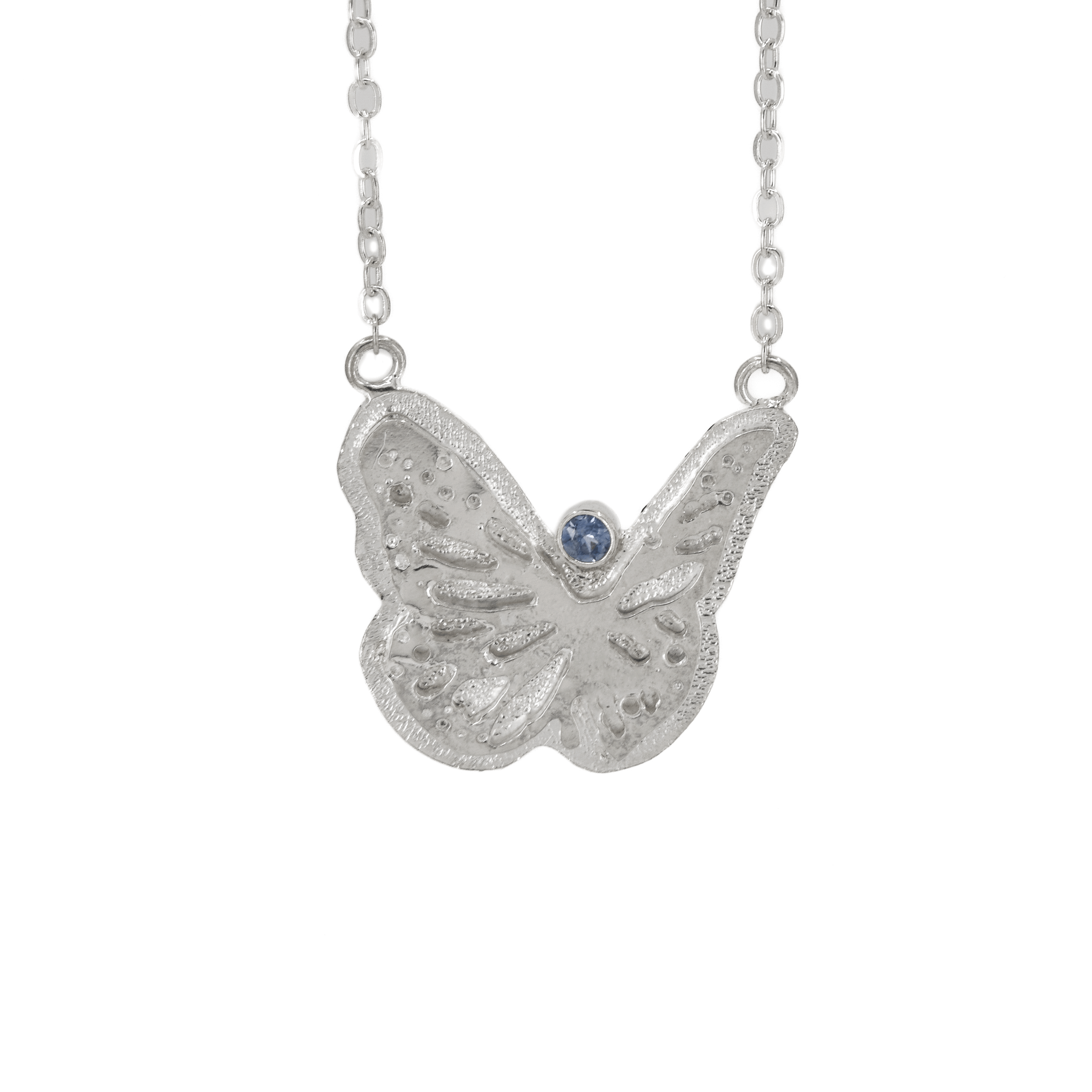 Large textured butterfly necklace in sterling silver with a faceted Teal Montana Sapphire round stone