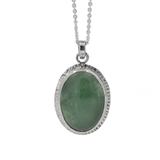 Green jade oval pendant with line textures around the edge of the bezel set stone