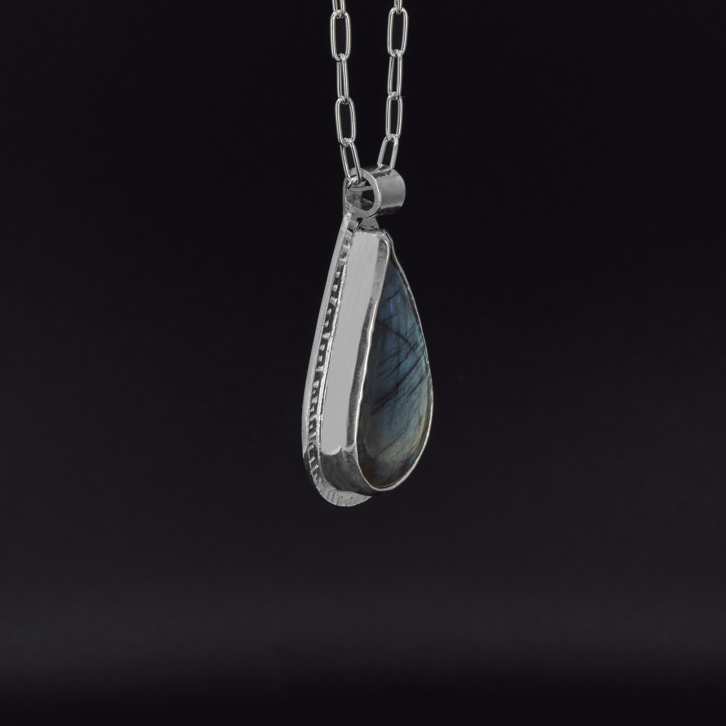 green statement pendant featuring a green labradorite stone, hanging on a paperclip style chain side view