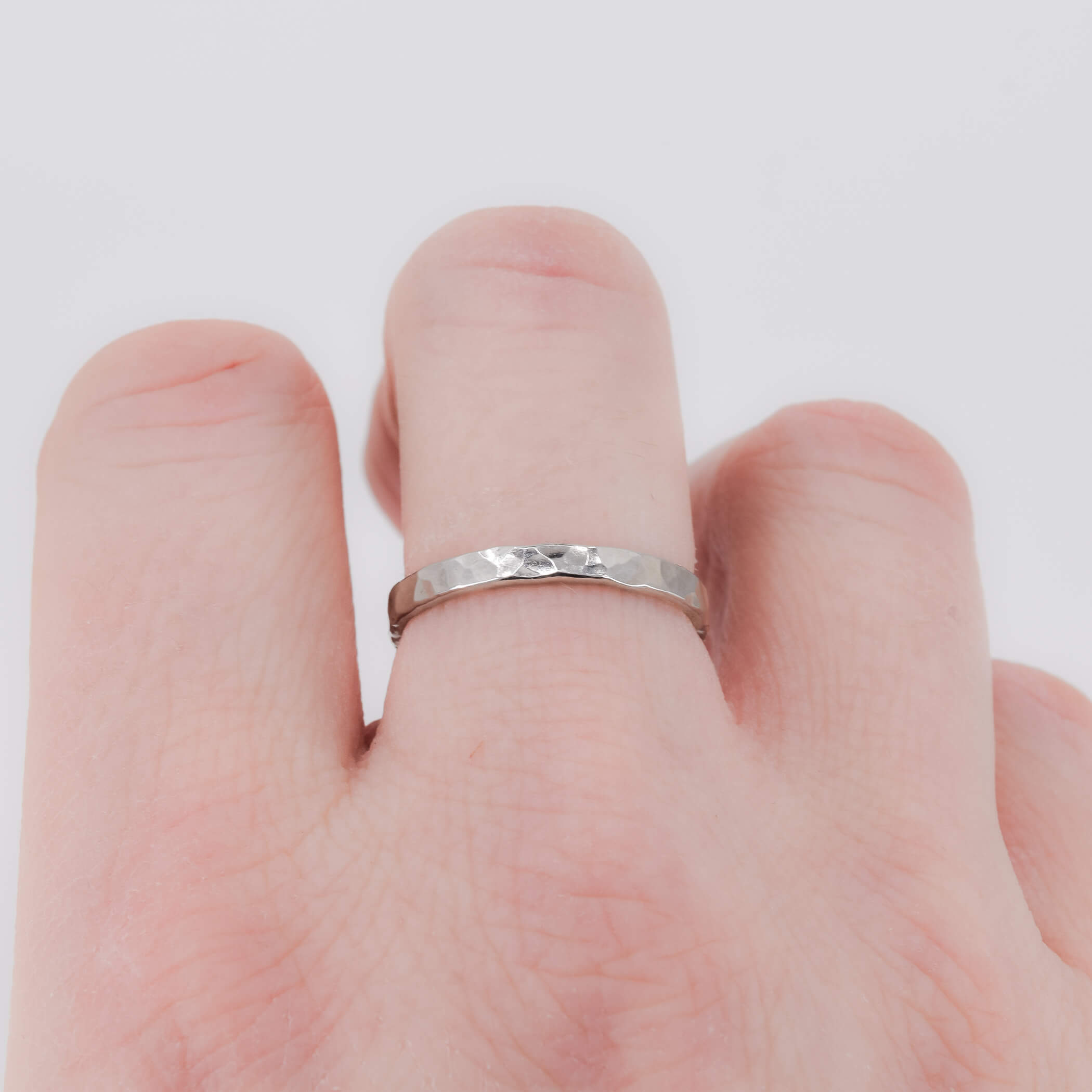 Hammered stacking ring in sterling silver worn on finger