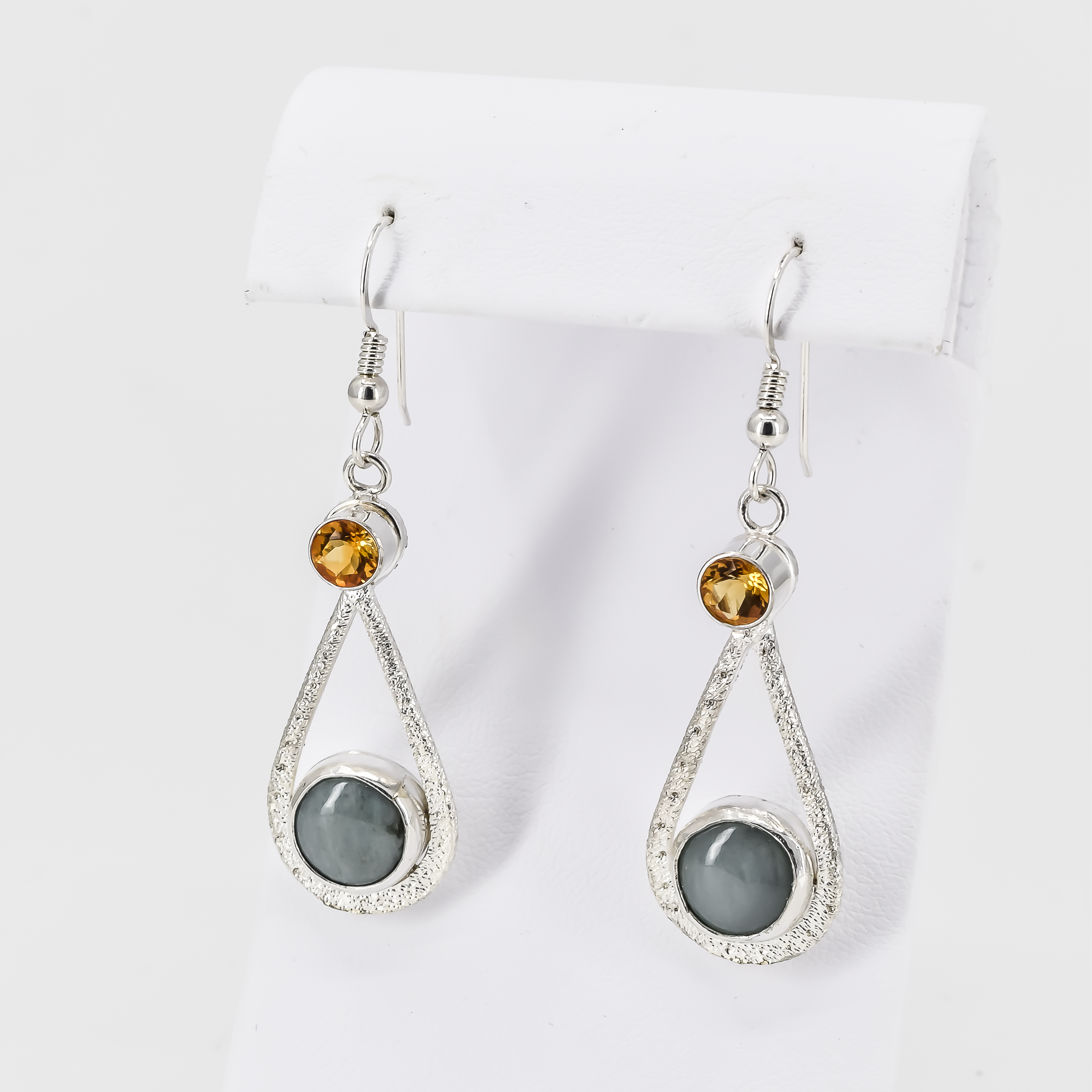 tear drop shaped sterling silver dangle earrings, featuring round faceted golden citrine stones on top and round pastel green jade stones on the bottom. The earrings have a stardust texture all the way through.