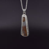 Montana agate sterling silver pendant necklace on a black background