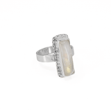 Long rectangular rainbow moonstone sterling silver ring with a hand textured border