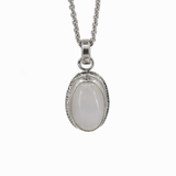 Oval moonstone pendant with a hand textured border hanging on a sterling silver cable chain