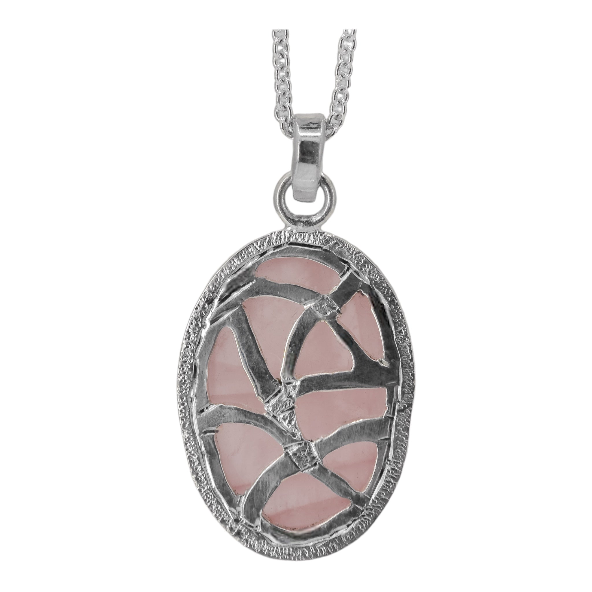 Back of an oval rose quartz pendant necklace in sterling silver, with a pierceed out random pattern and hand engraved lines.