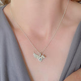 Sterling silver and sapphire angel wings necklace in sterling silver worn by a model