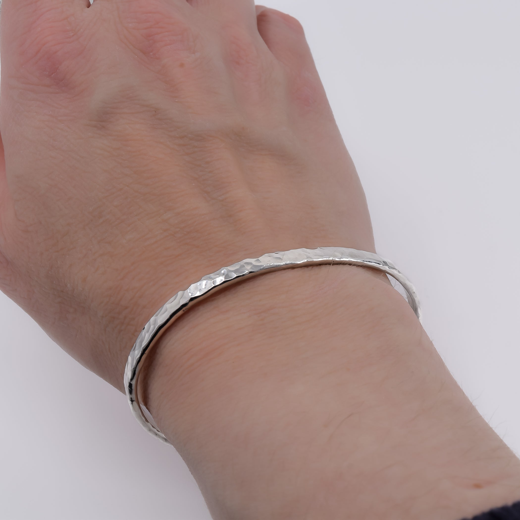 Textured sterling silver cuff bracelet on female wrist