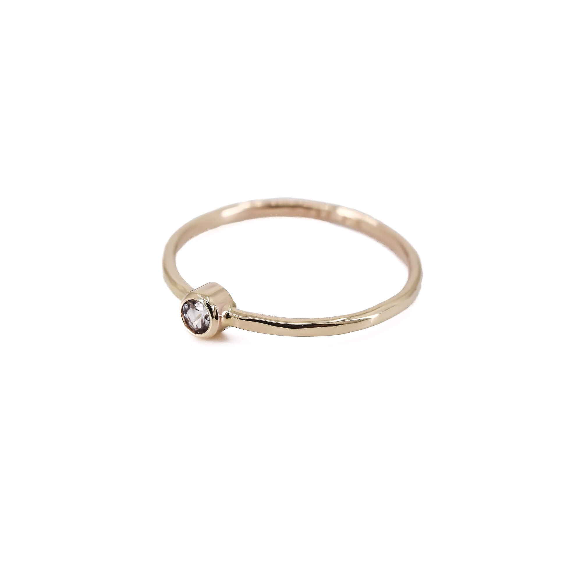 faceted, thin 14K yellow gold stacking ring with white sapphire