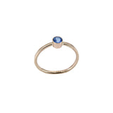 thin faceted 14K yellow gold ring with ice blue topaz stone