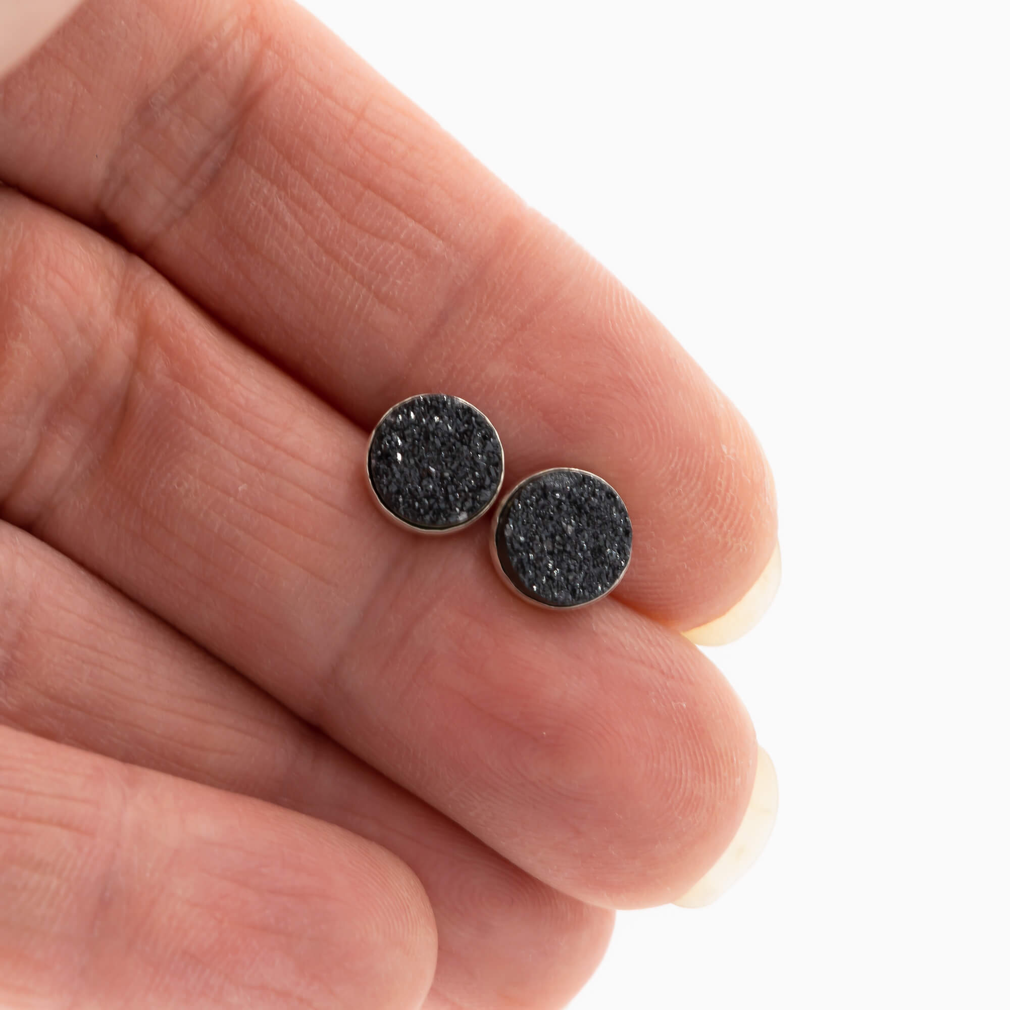 8mm black druzy stud earrings in sterling silver shown for scale