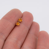 Mexican fire opal faceted stones set in 14K recycled solid gold shown in hand for scale