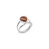Cantera opal in a heart shape in a sterling silver ring, which has a textured double band.
