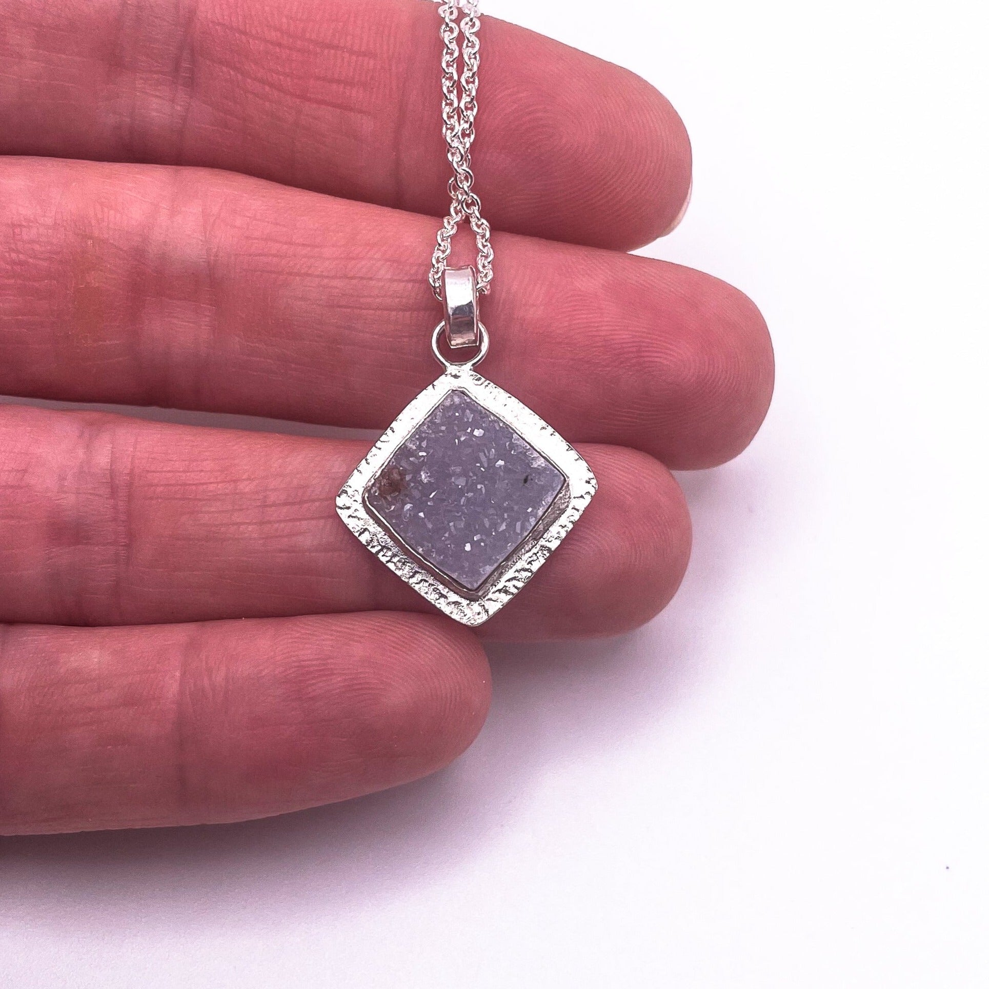 Square lavender druzy pendant necklace in sterling silver shown for scale