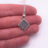 Square lilac druzy pendant necklace in sterling silver shown in hand for scale