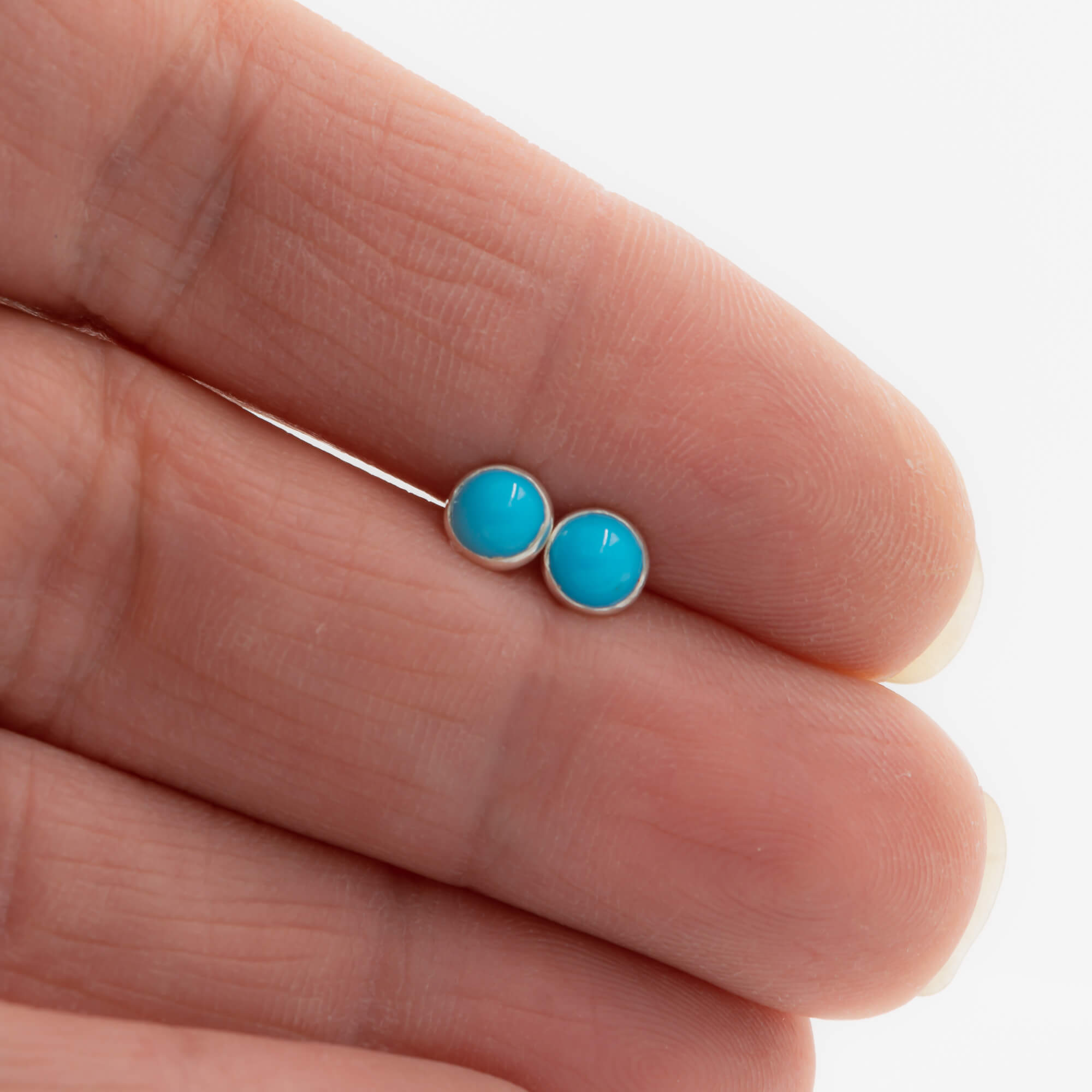 5mm sleeping beauty turquoise stud earrings in sterling silver shown for scale