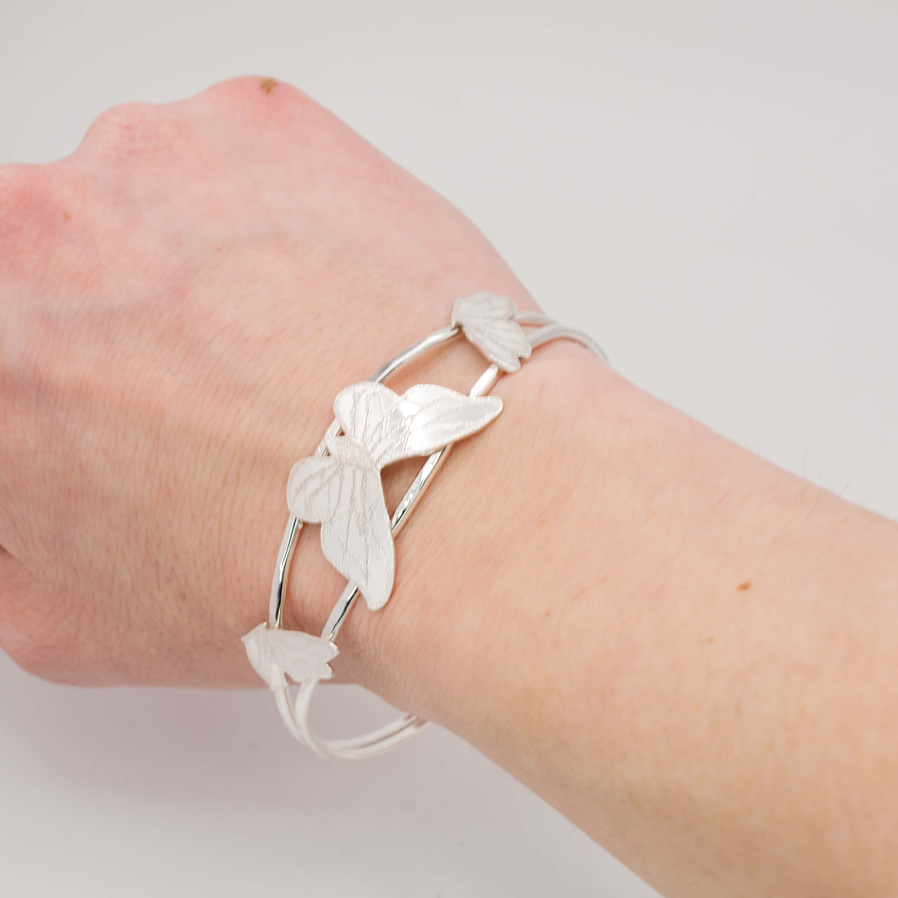 Sterling silver butterfly cuff bracelet on wrist